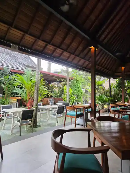 Open-air interior of Laughing Buddha Bar in Bali with tropical plants and lounge seating — salsa, bachata venue in Bali