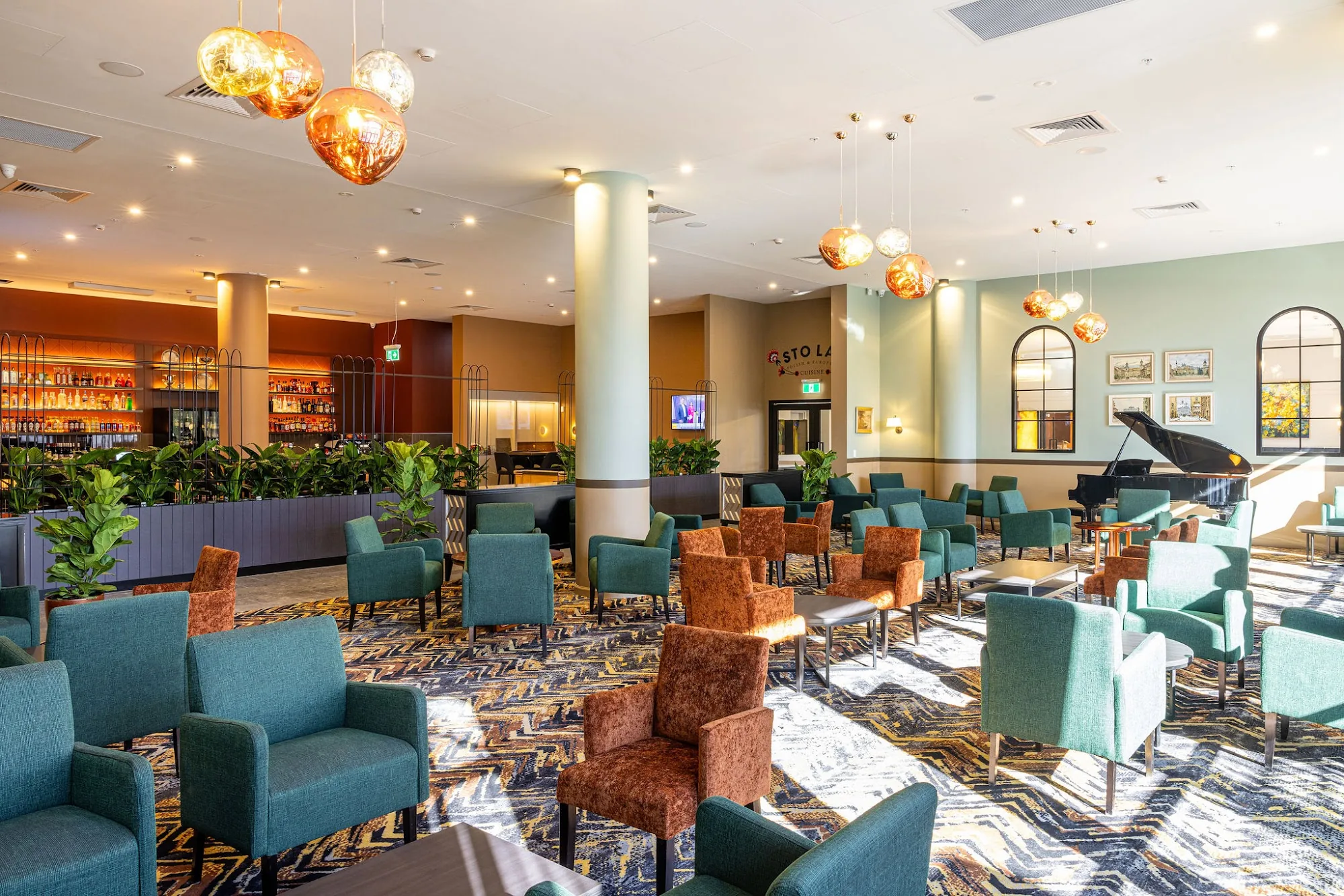 Bar lounge with chandeliers and seating at Polish Club Ashfield, Sydney