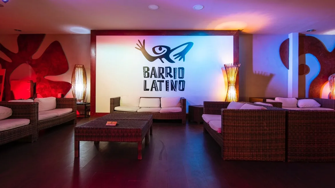 Lounge area with Barrio Latino logo wall and club lighting at Salsa Nightclub in Rome