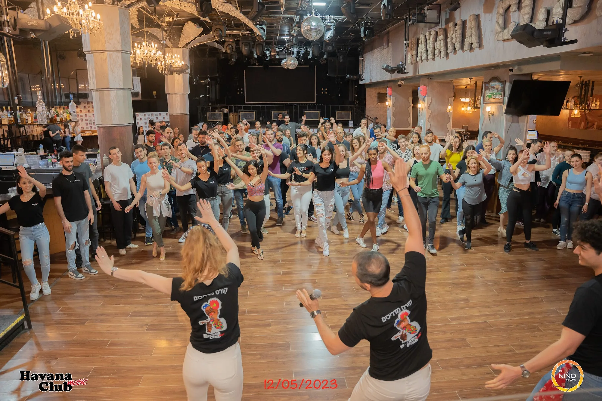 Large salsa dance group class on the dance floor at Havana Club Tel Aviv