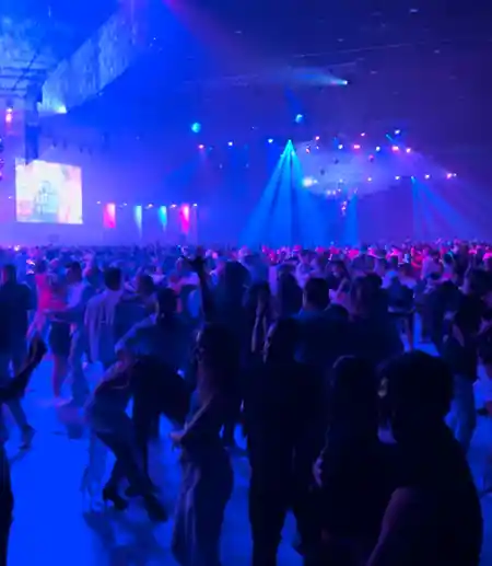 Packed social dance floor at The Victorian in Los Angeles with hundreds of dancers under vibrant blue and purple lights at a salsa and bachata night