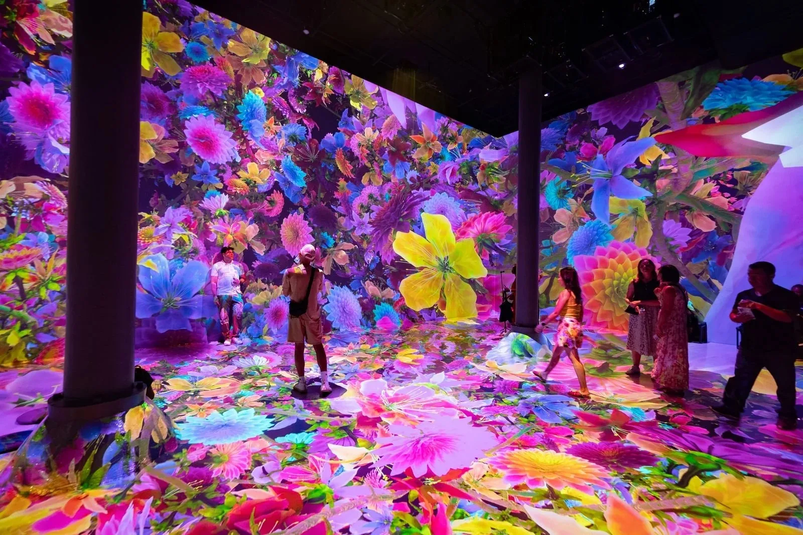 Immersive floral light installation event at Chelsea Market New York with crowd of attendees