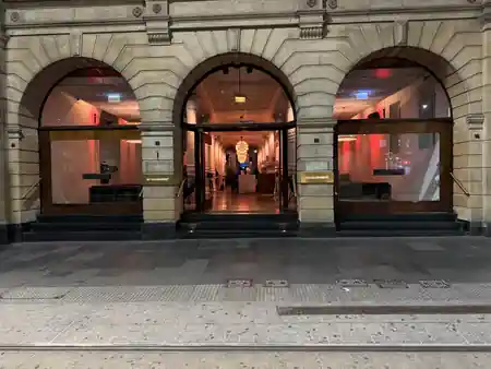 Triple sandstone arches mark the illuminated Establishment Bar entrance in Sydney CBD at night — salsa, bachata, merengue venue in Sydney