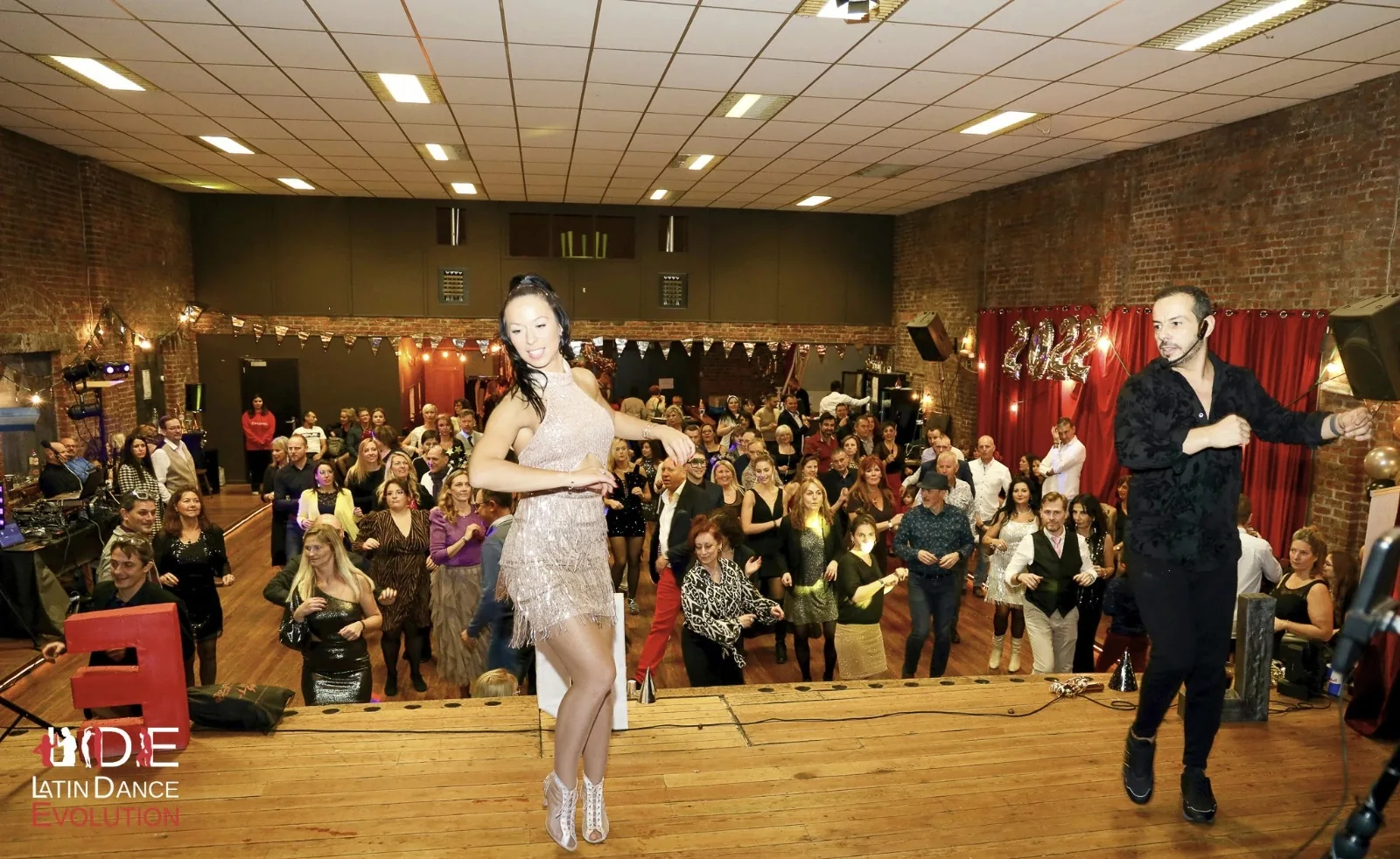 Instructor couple performing for the crowd at a Latin Dance Evolution party in Brussels