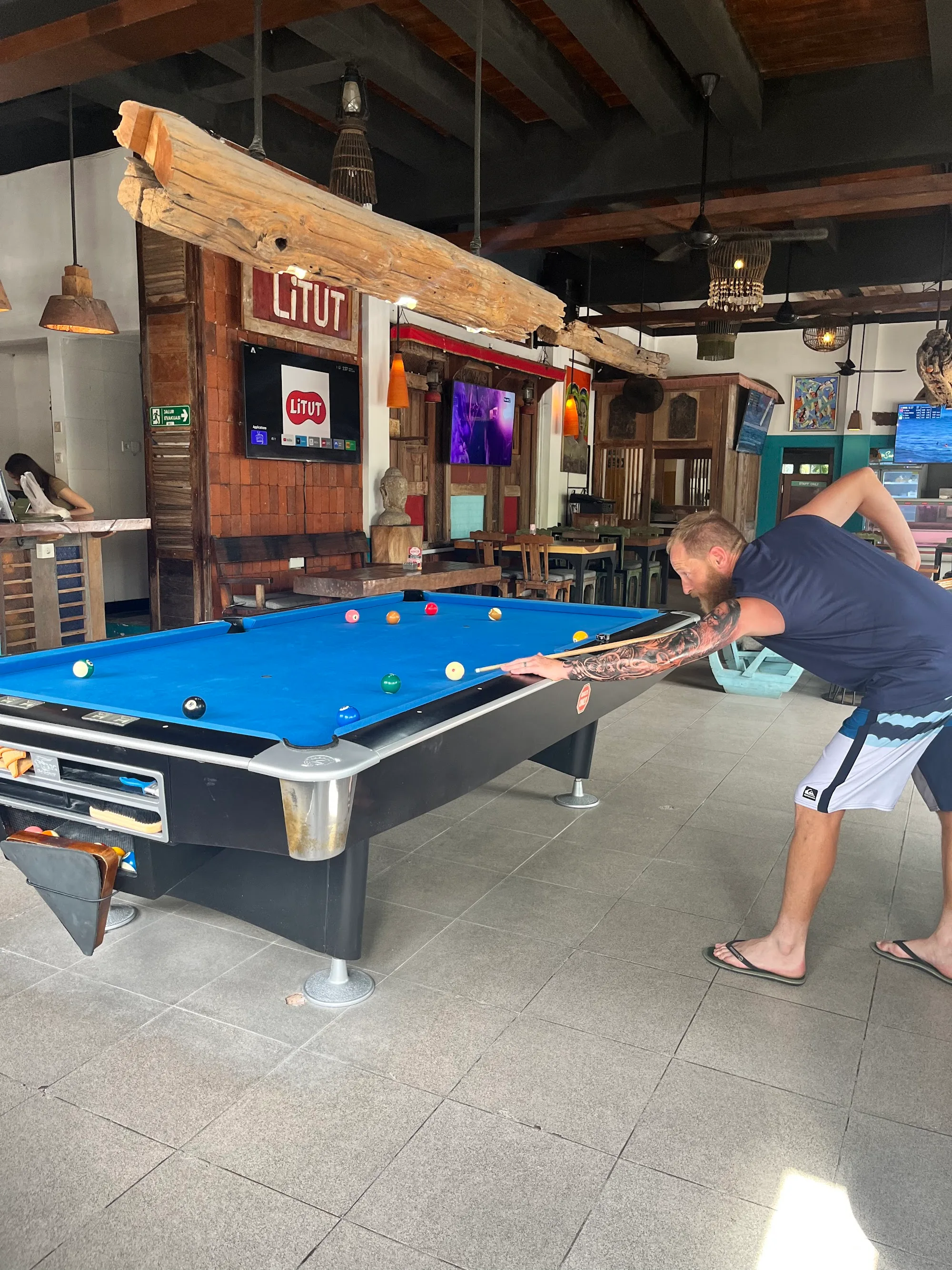 Pool table and bar area with LITUT signage at Litut Bar & Restaurant in Bali