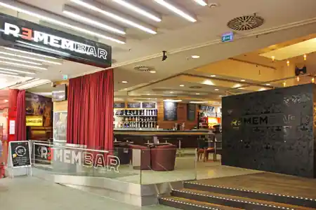 Remembar Frankfurt — branded bar entrance inside shopping mall with REMEMBAR neon and red curtain — bachata, salsa venue in Linz