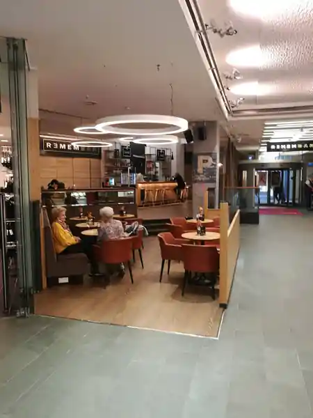 Remembar Frankfurt — cosy bar seating area with ring light fixtures and bar counter visible — bachata, salsa venue in Linz