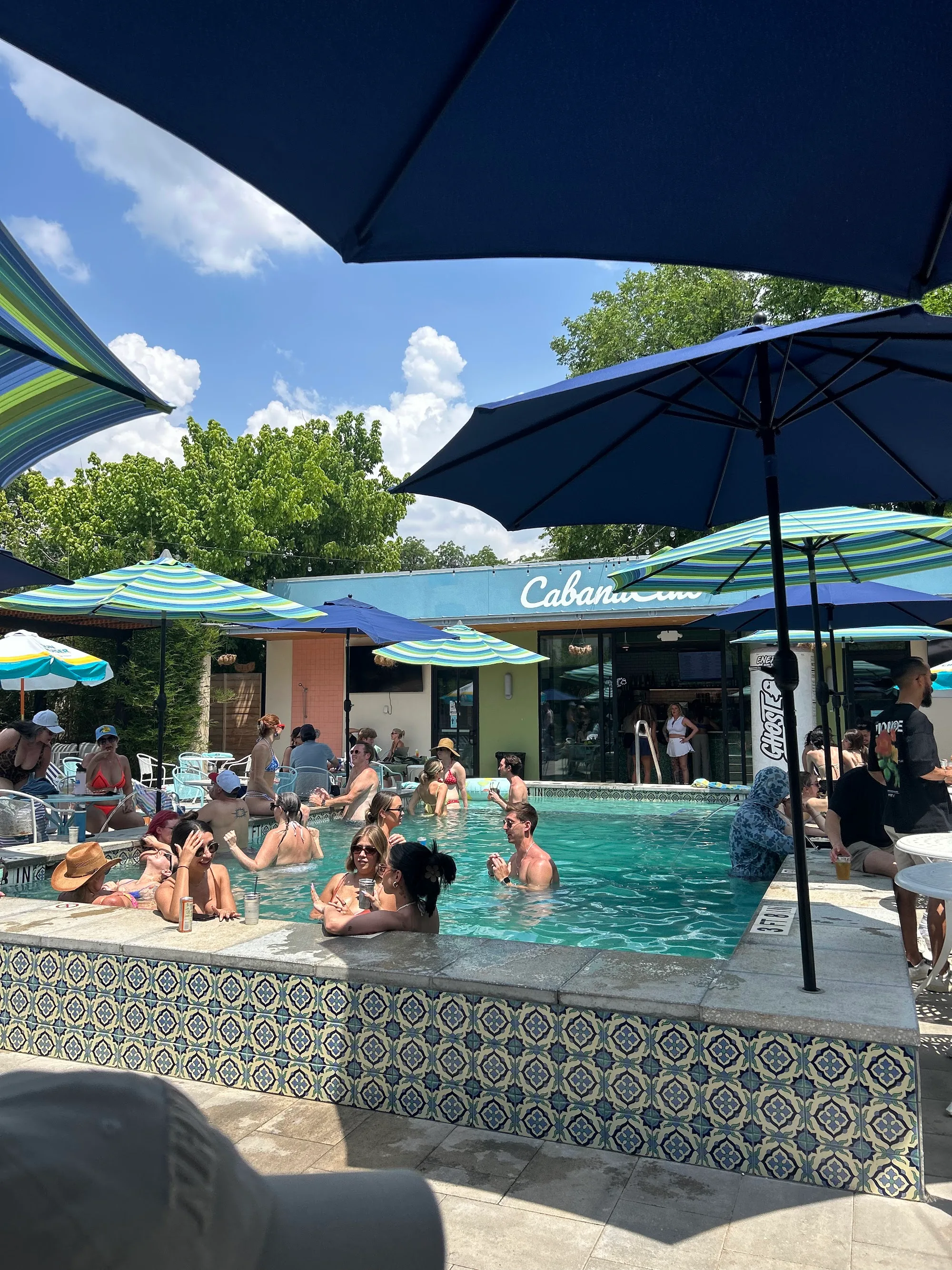 Cabana Club Austin pool party with crowd and Cabana Club sign