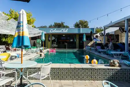 Cabana Club Austin exterior with tropical palm trees and resort-style cabana lounge area — salsa, bachata venue in Austin
