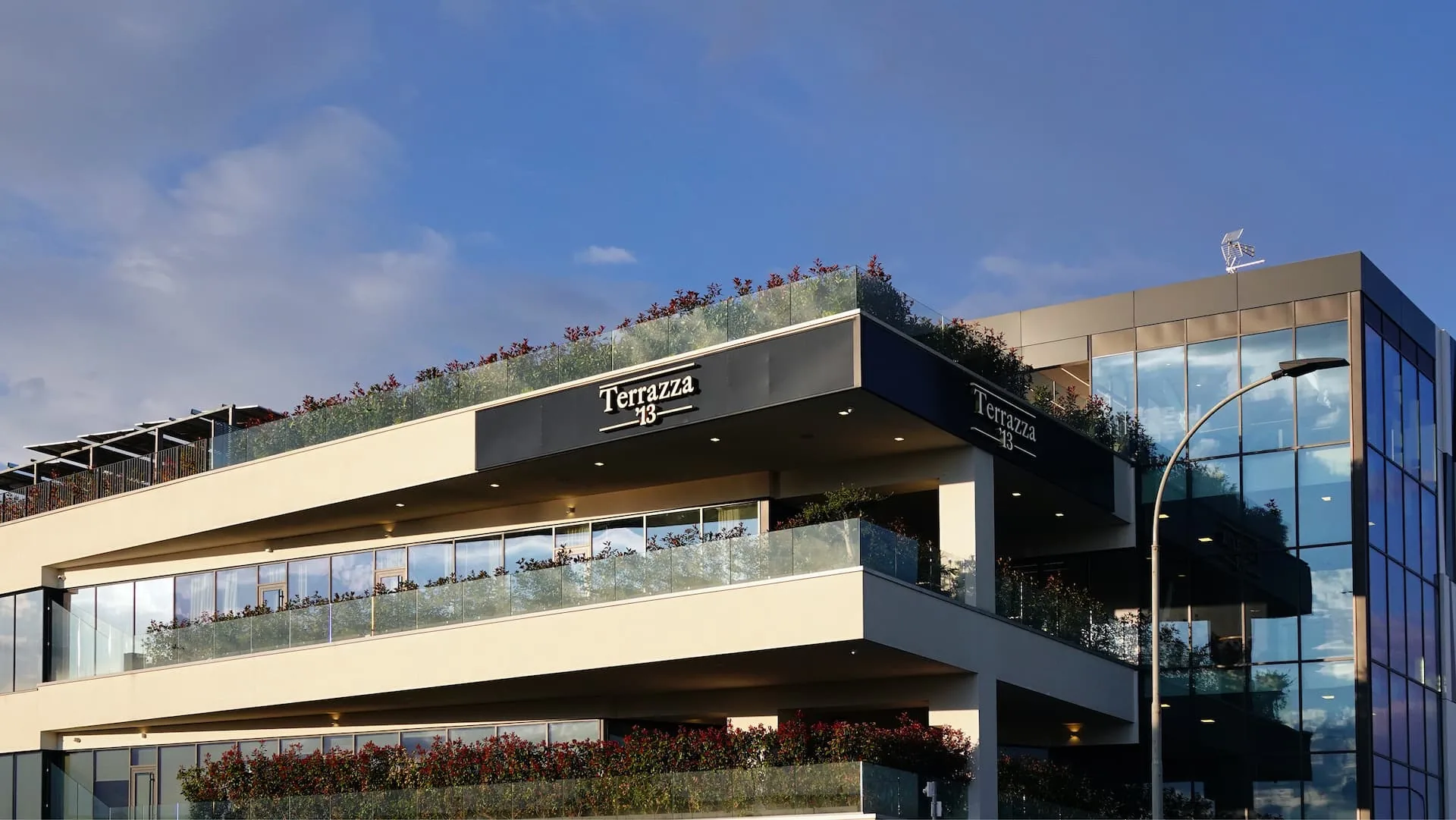 Terrazza 13 building exterior with rooftop signage in Milan