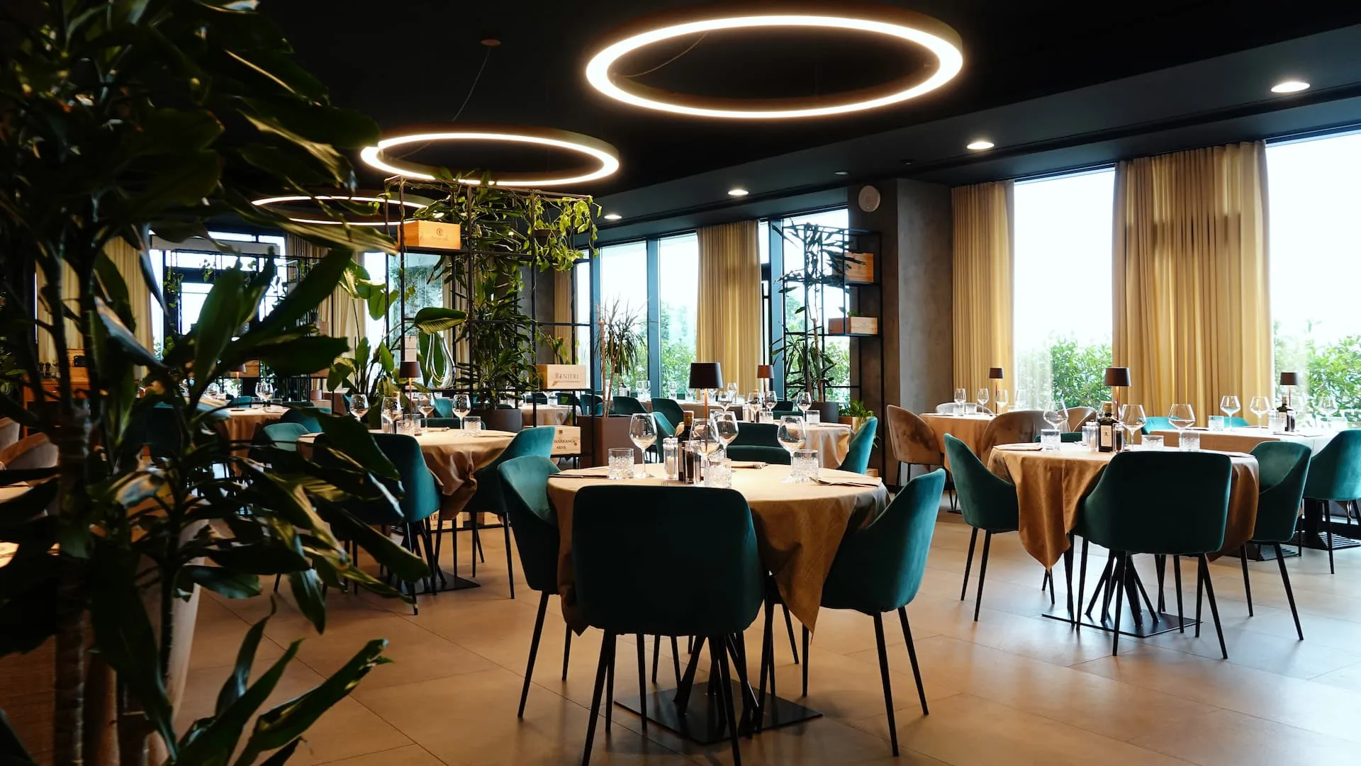 Spacious Terrazza 13 interior with ring lighting, plants, and panoramic windows in Milan