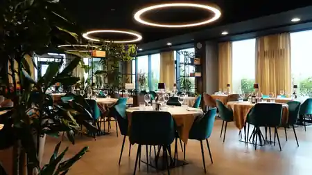 Spacious Terrazza 13 interior with ring lighting, plants, and panoramic windows in Milan — bachata, salsa venue in Milan