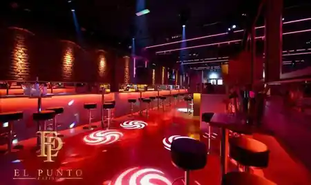 Dance floor at El Punto Latino Amsterdam lit in red with spinning light floor projections — salsa, bachata, kizomba venue in Amsterdam