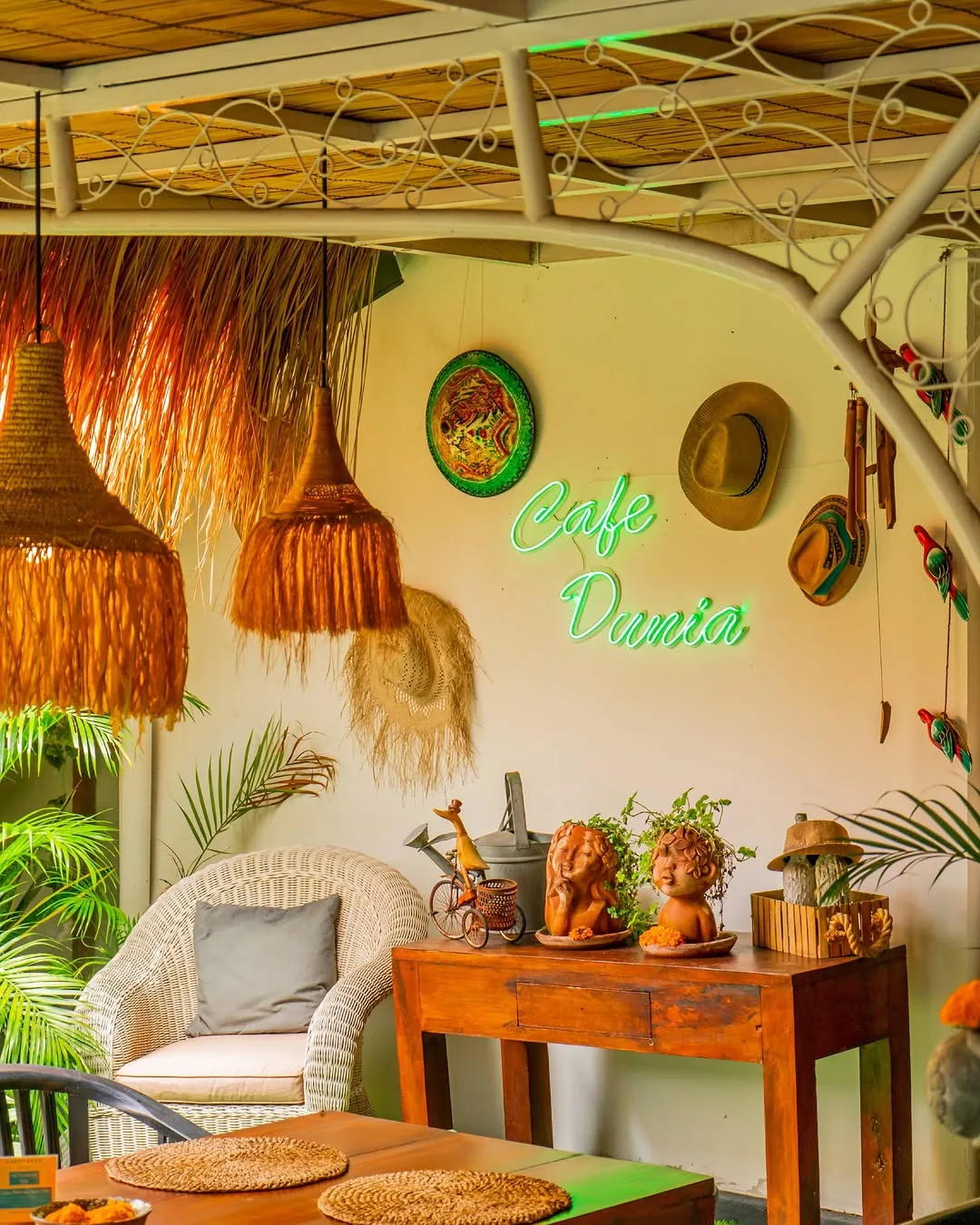 Cafe Dunia neon signage and tropical decor in the lounge area, Bali
