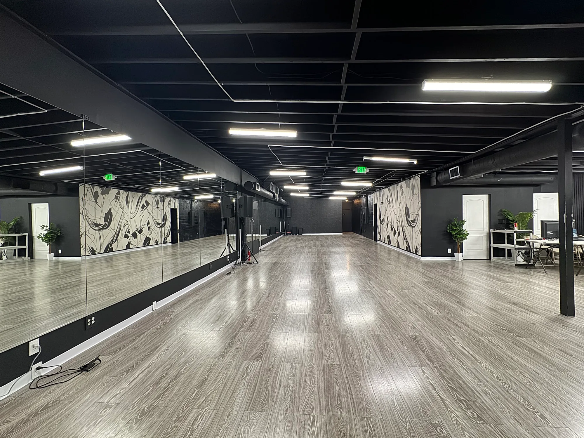 Large mirrored dance floor with wood-look flooring at RYG Dance Studio in North Hollywood