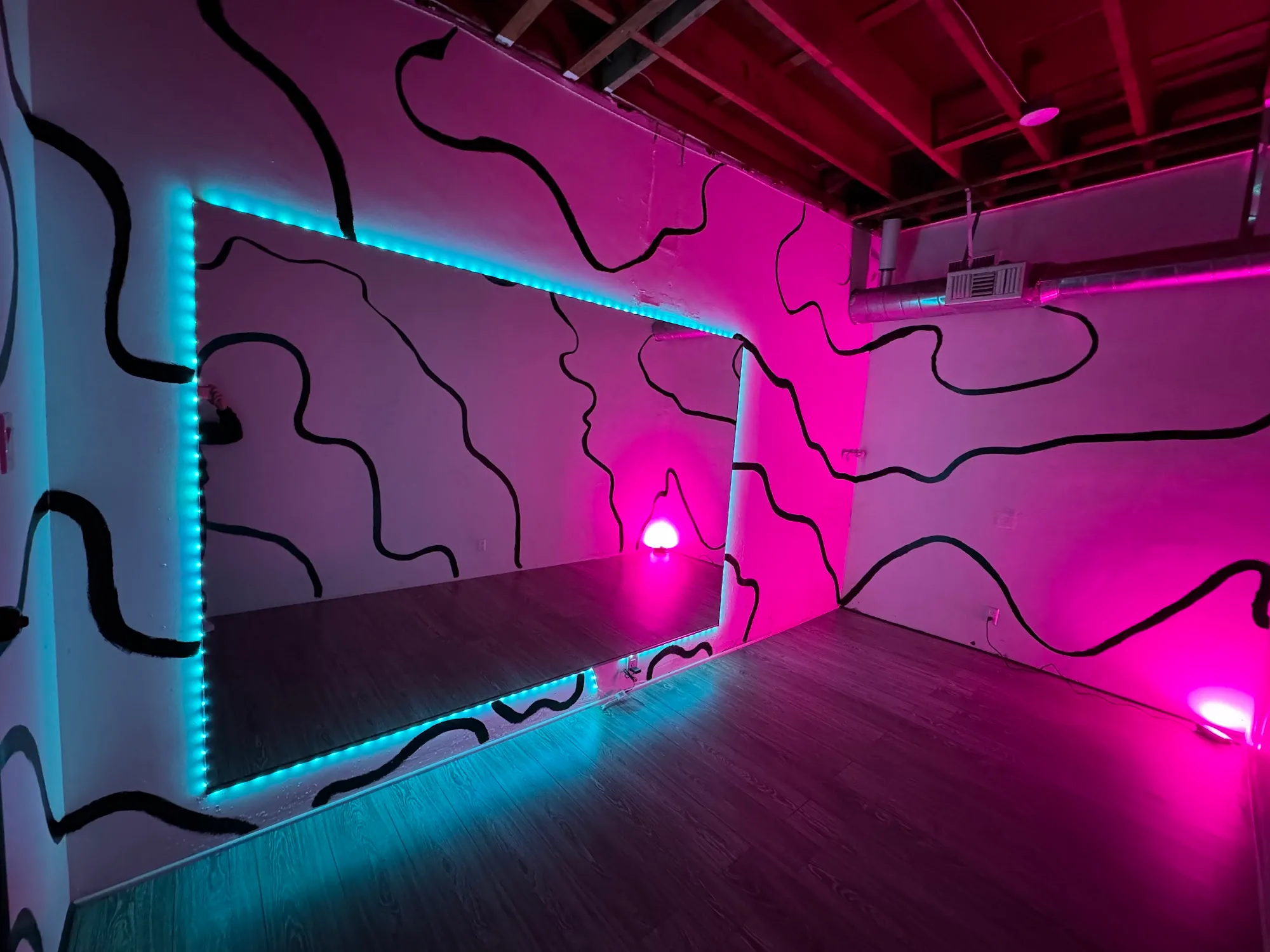Neon-lit mirrored dance room with mural walls at RYG Dance Studio in North Hollywood