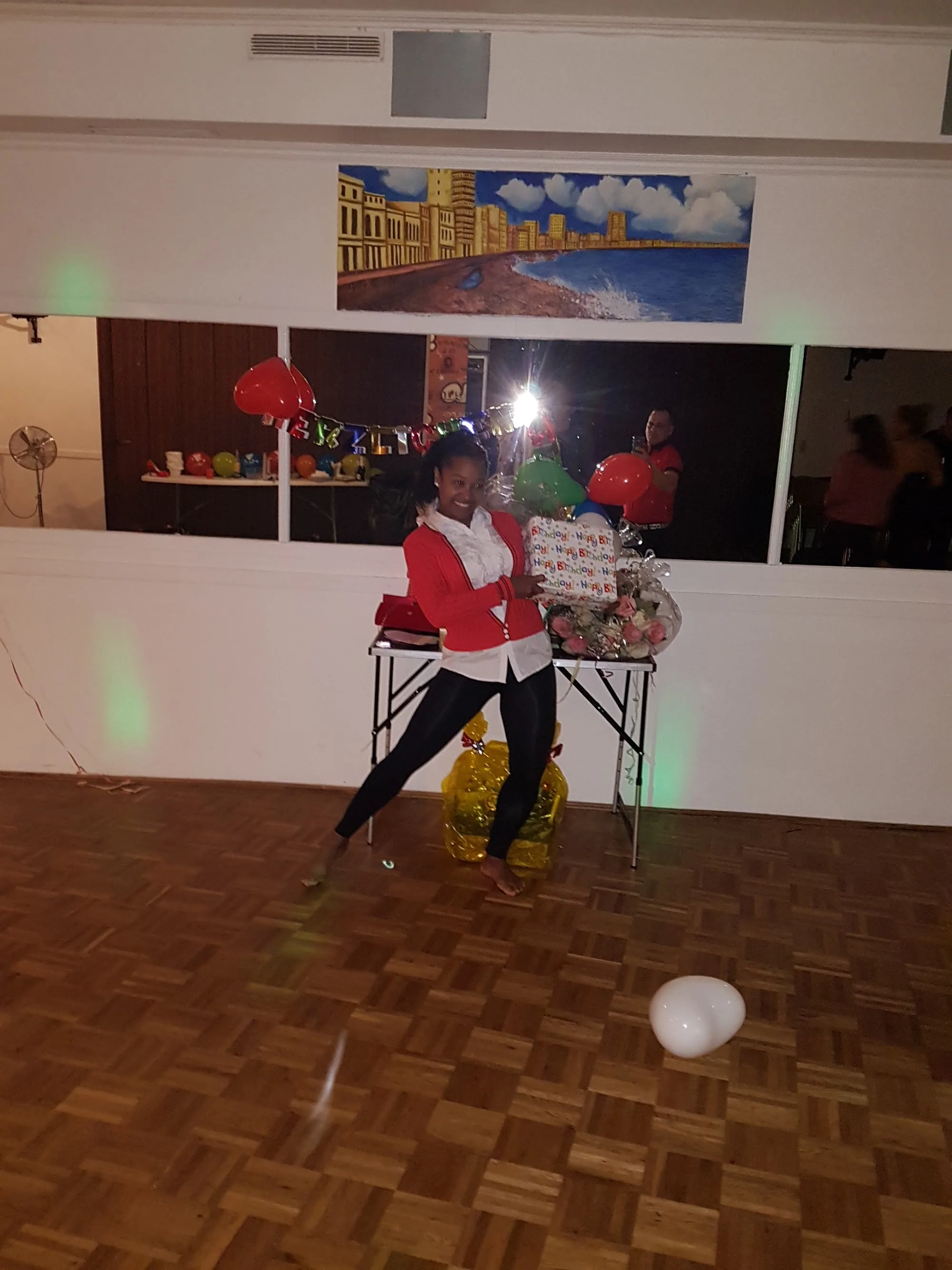 Woman dancing on wooden parquet floor at Casa Cultural Bremen party
