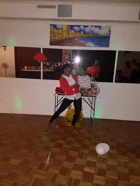 Woman dancing on wooden parquet floor at Casa Cultural Bremen party — salsa, bachata, kizomba venue in Bremen