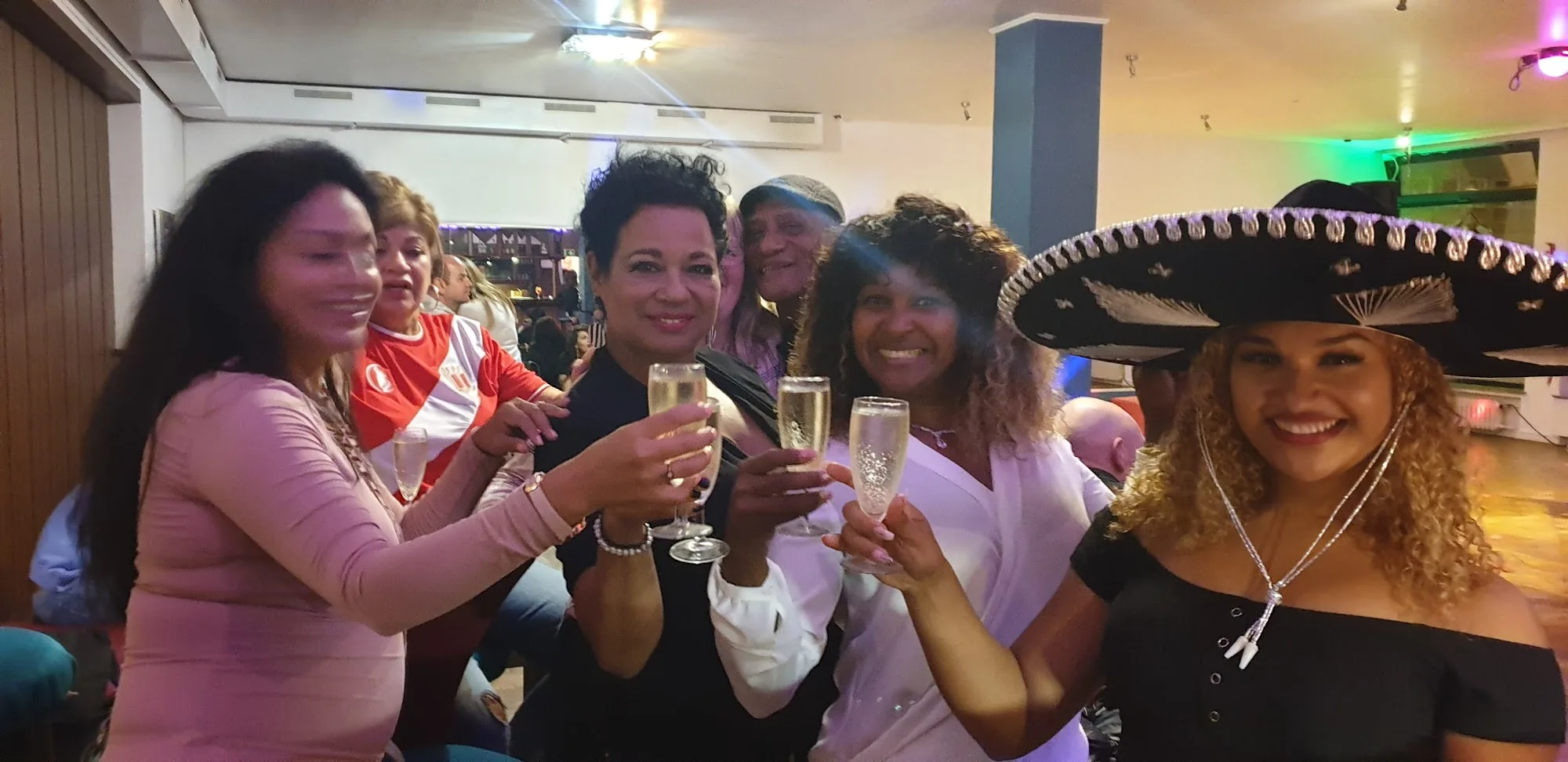 Latin party group celebrating with champagne at Casa Cultural e.V. Bremen