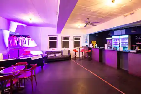 Brotfabrik Frankfurt venue interior with bar and dance floor under purple lighting — salsa, bachata, kizomba venue in Frankfurt