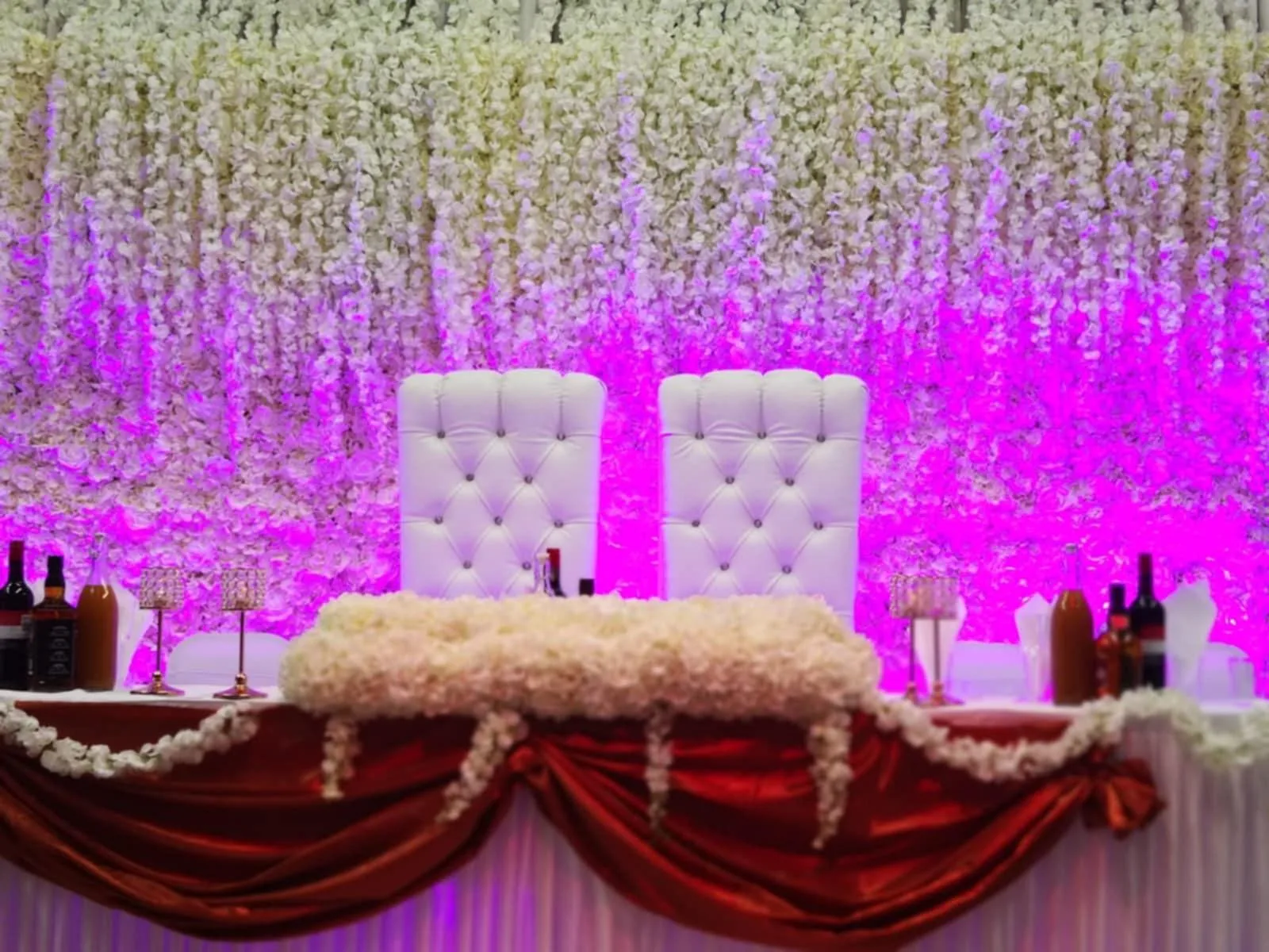 Floral backdrop and stage lighting inside IBEX Venue London event hall