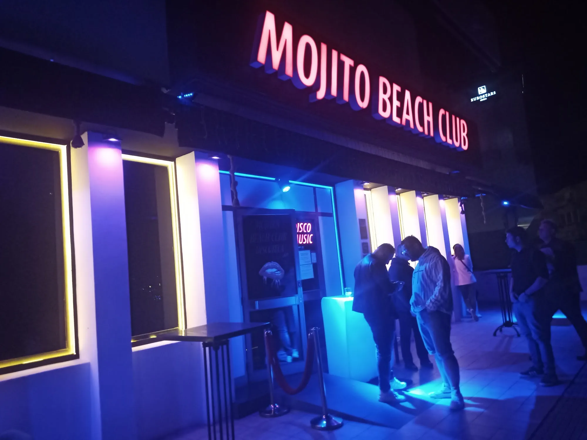 Mojito Beach Club neon-lit exterior entrance in Barcelona at night