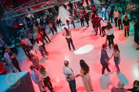 Overhead view of dancers on the Mambo Swing dance floor in Madrid with red lighting — salsa, bachata venue in Madrid