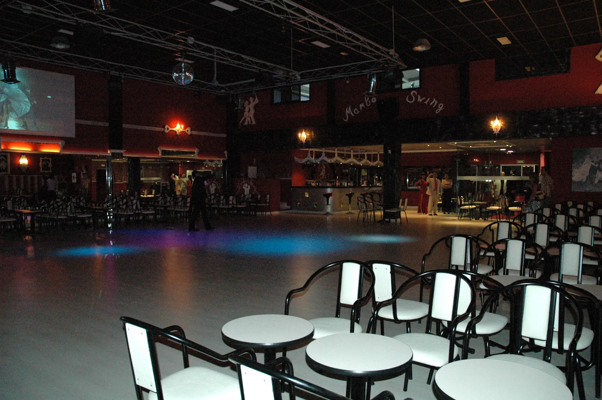 Mambo Swing dance hall interior with empty floor and branded wall signage in Madrid