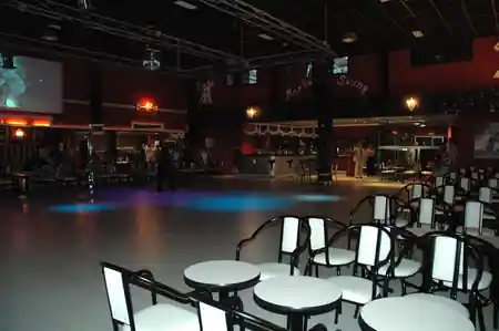 Mambo Swing dance hall interior with empty floor and branded wall signage in Madrid — salsa, bachata venue in Madrid