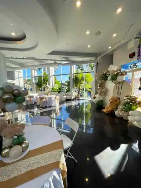 Bright interior event hall at iVenueLA in Los Angeles with floor-to-ceiling windows and polished black floor — salsa, bachata venue in Los Angeles
