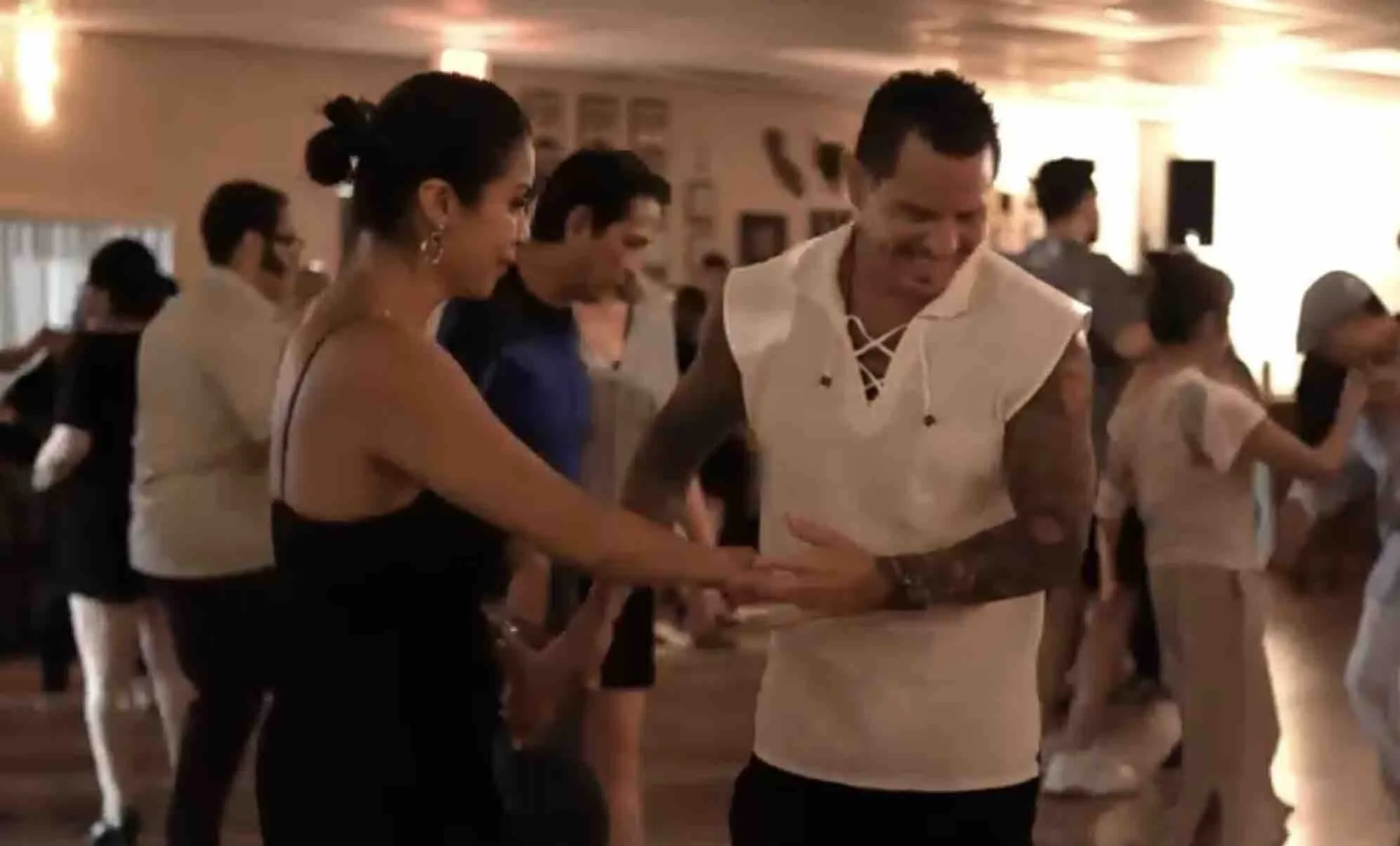 Couples social-dancing salsa on the wooden floor at OC Salsa Dance Studio in Fountain Valley
