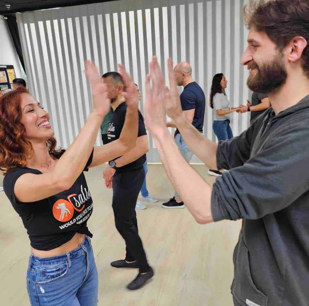 Partner dancing during a salsa class at OC Salsa Dance Studio in Fountain Valley