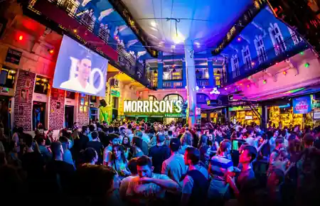 Outdoor courtyard at Morrison's 2 Klub Budapest packed with a night-time party crowd — bachata venue in Budapest