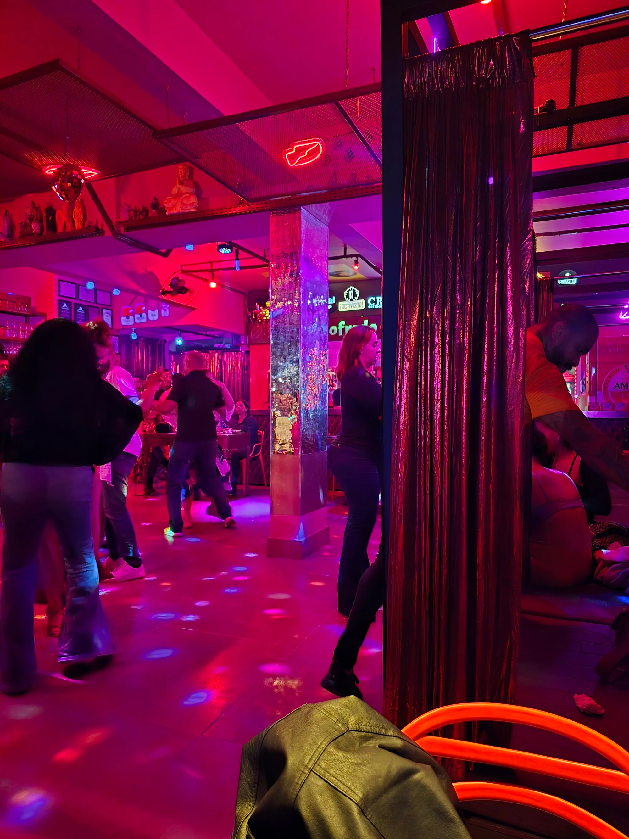 Dance floor with red lighting and crowd at Godofredo Bar Brasília