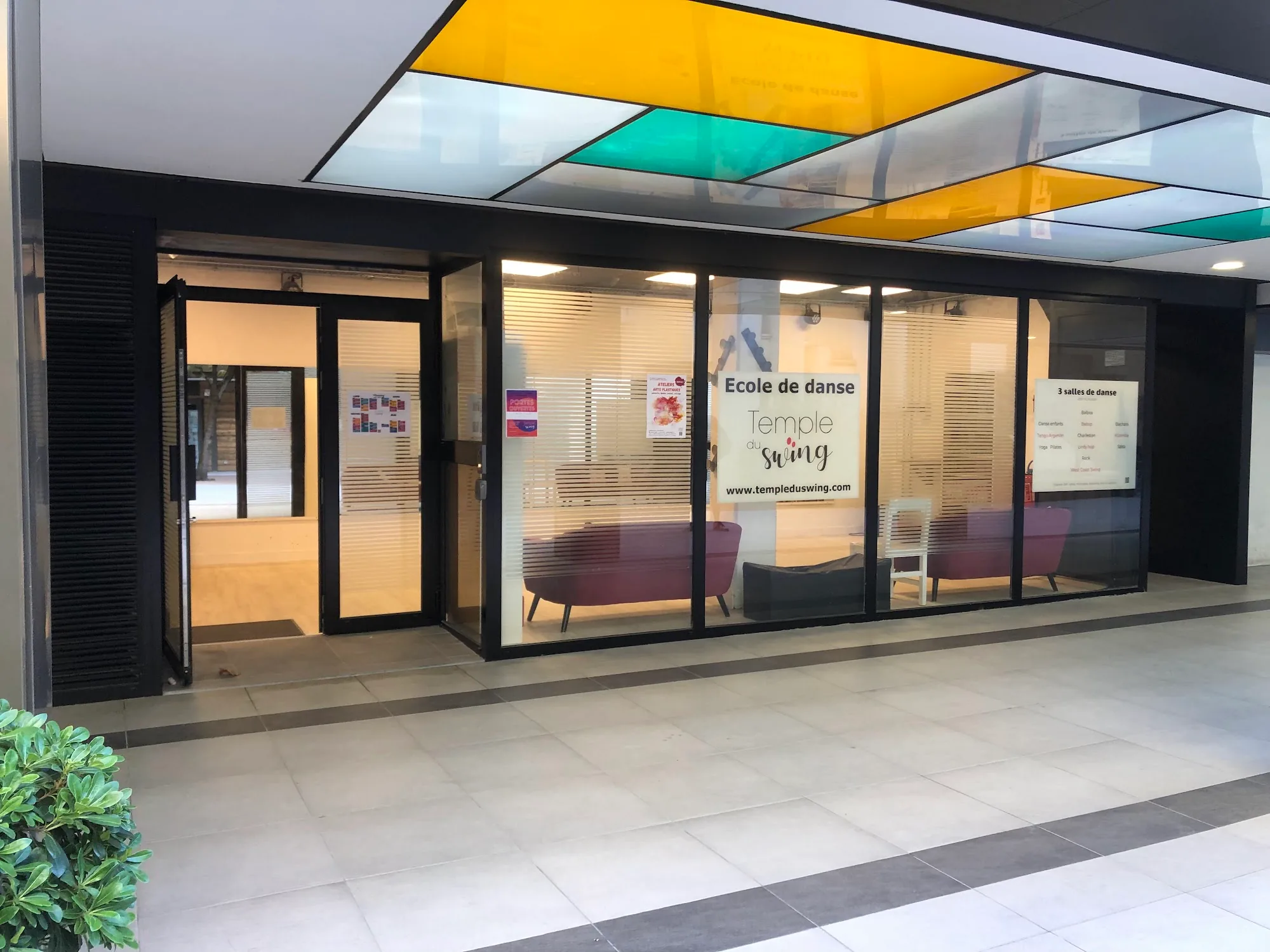 Daytime exterior of Temple du Swing dance school in Paris with stained-glass canopy