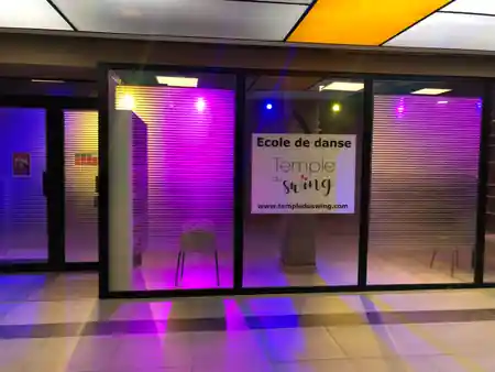 Temple du Swing storefront in Paris lit with purple and yellow ambient lighting at night — zouk venue in Paris