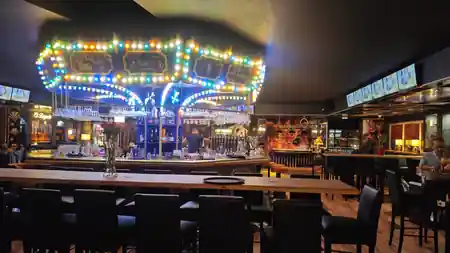 Colorful bar with carousel chandelier at La Casa del Brigante Marseille — salsa venue in Marseille