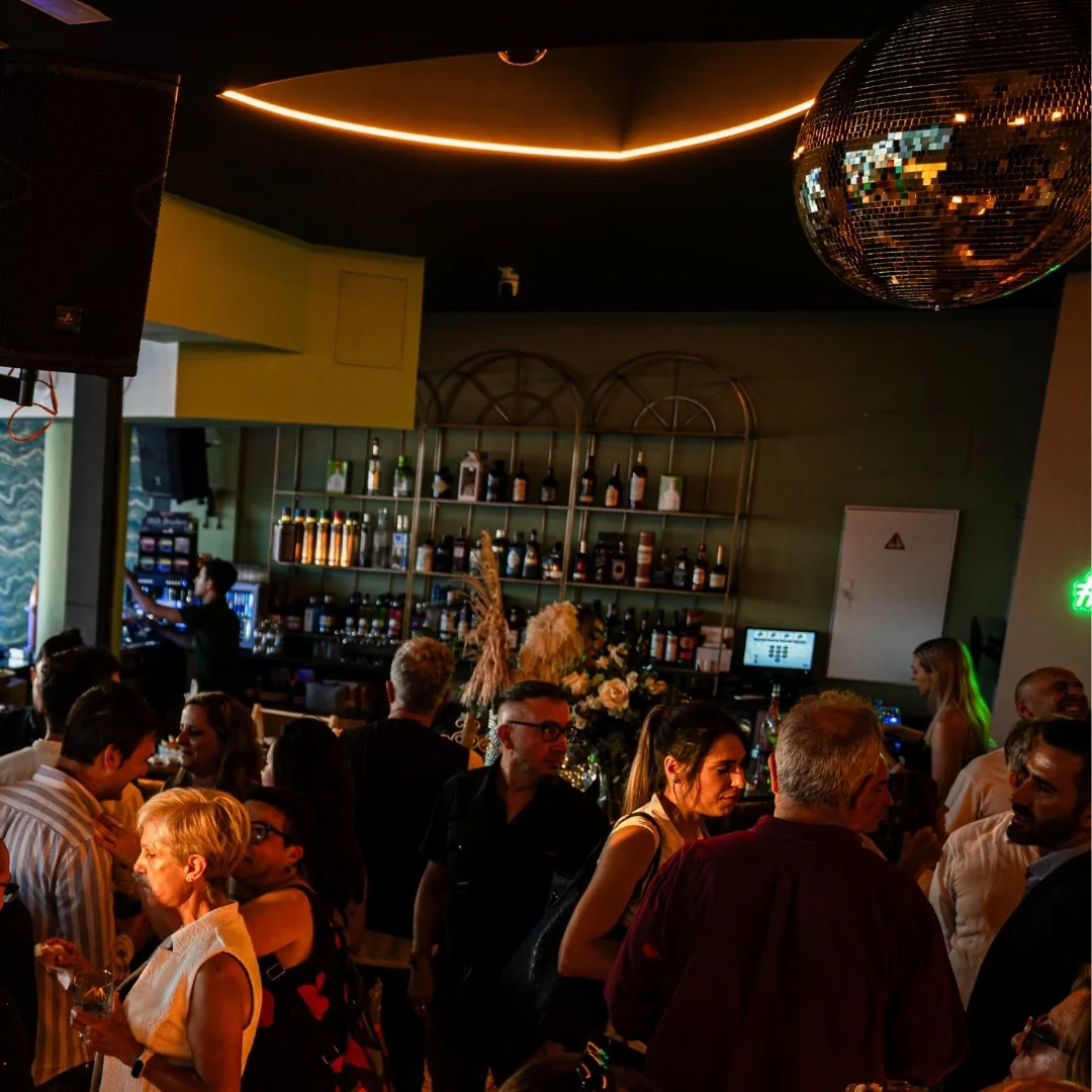 Bar interior with crowd and disco ball at Sausalito Alicante