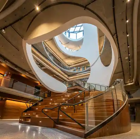 Dramatic spiral staircase atrium inside Victorian Pride Centre Melbourne — bachata, salsa, zouk venue in Melbourne