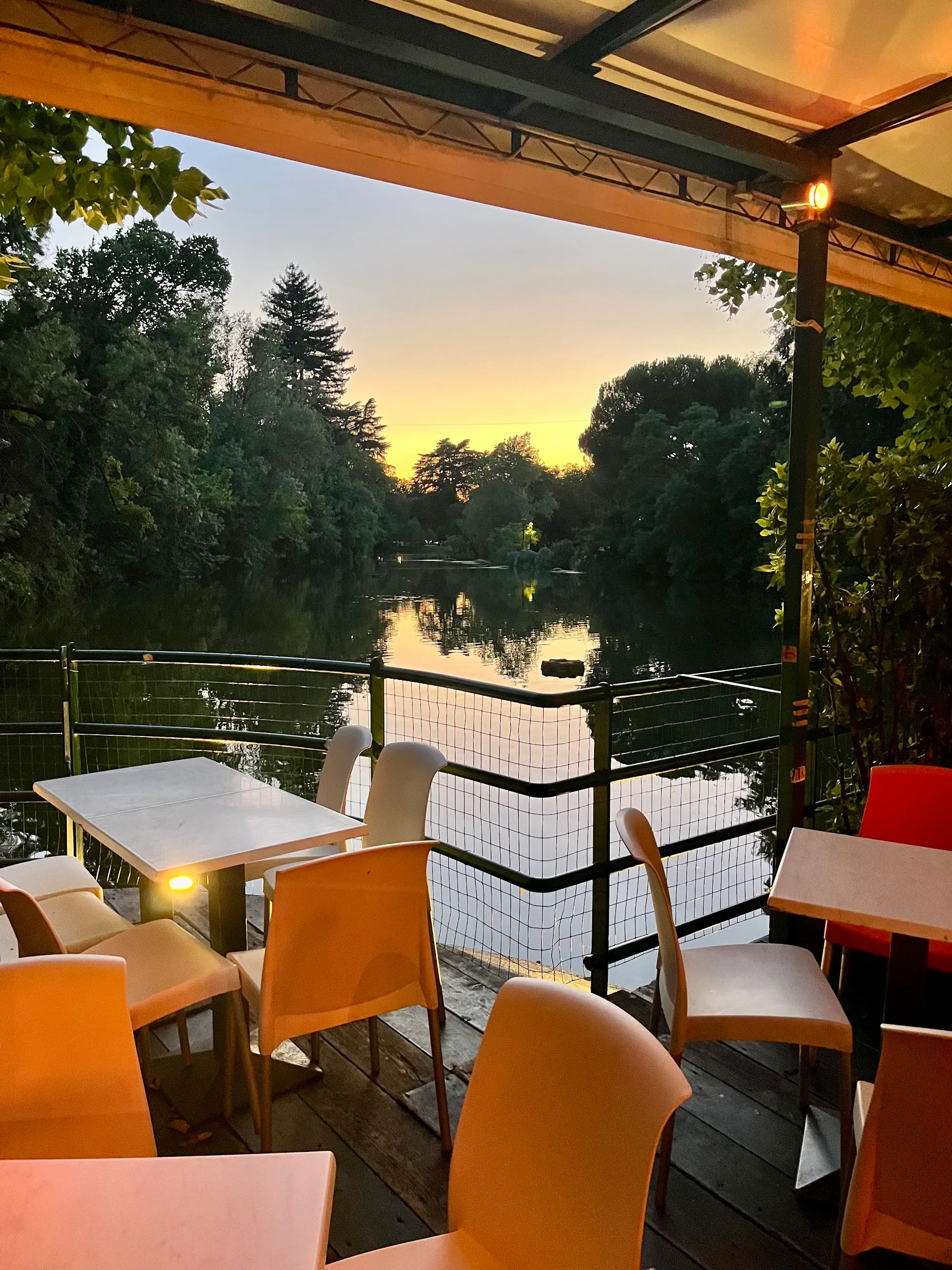 Chalet dei Giardini Margherita outdoor terrace at sunset with lake view Bologna
