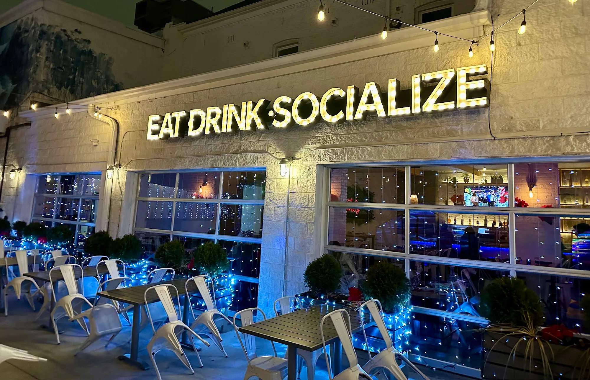 Barcocina West Town exterior at night with Eat Drink Socialize sign and string lights, Chicago — bachata, salsa venue in Chicago