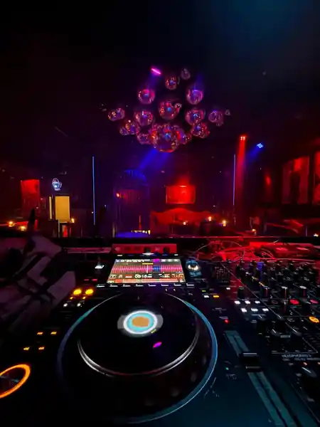 DJ booth with Pioneer decks at Red Ruby nightclub in Bali, overlooking the dance floor with mirror ball ceiling — salsa, bachata, kizomba venue in Bali