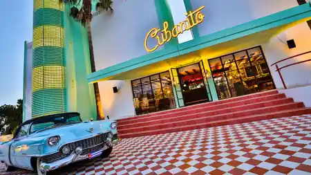 Cubanito Ibiza hotel exterior with vintage car — salsa, bachata venue in San Antonio, Ibiza