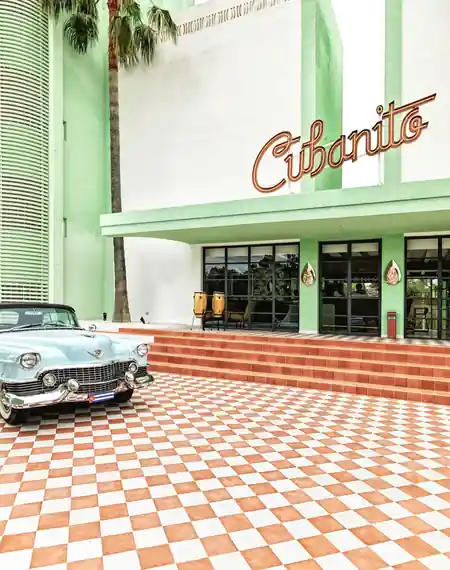 Malecón de Cubanito branded exterior with classic Cuban car outside in Munich Germany — salsa, bachata venue in San Antonio, Ibiza