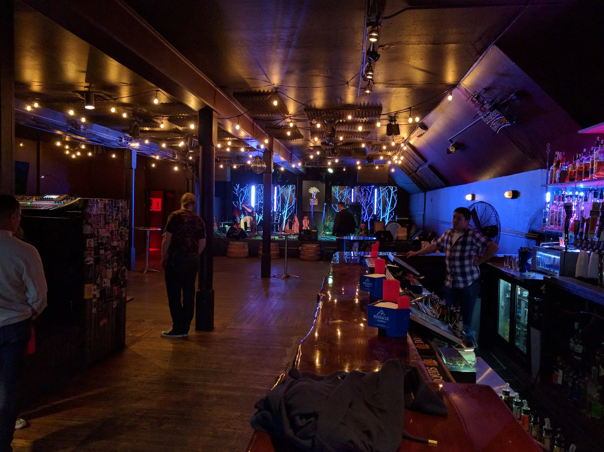 Wide interior view of bar and dance floor with string lights at Neck of the Woods San Francisco