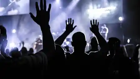 Crowd with raised hands under stage lights at Downstairs At The Dome in London — salsa venue in London