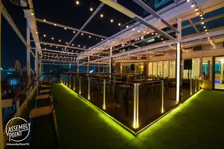 Rooftop terrace with string lights and seating at Assembly Point Thonglor, Bangkok — salsa, bachata, kizomba venue in Bangkok