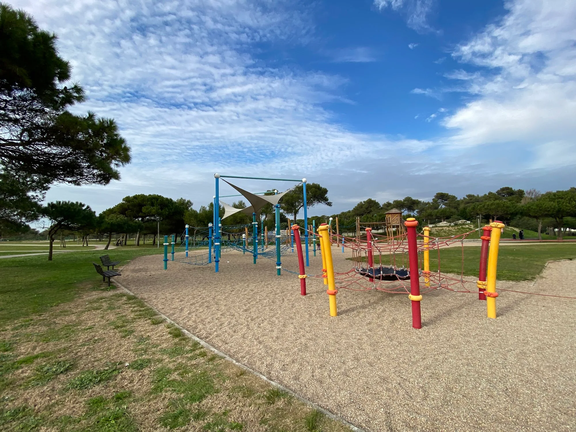Open lawn and playground area at Parque Urbano da Costa da Caparica