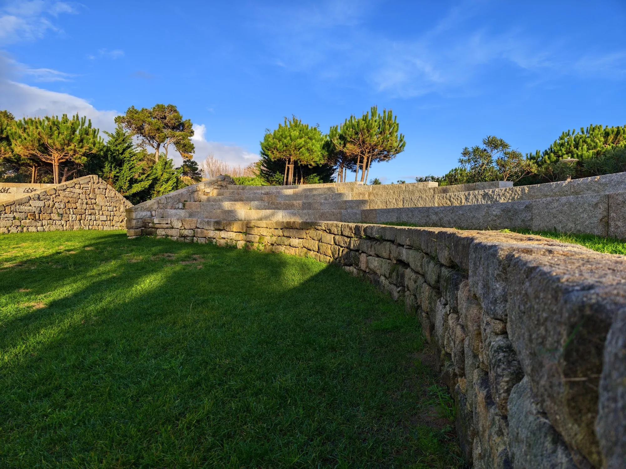 Stone amphitheater and grass terraces at Parque Urbano da Costa da Caparica