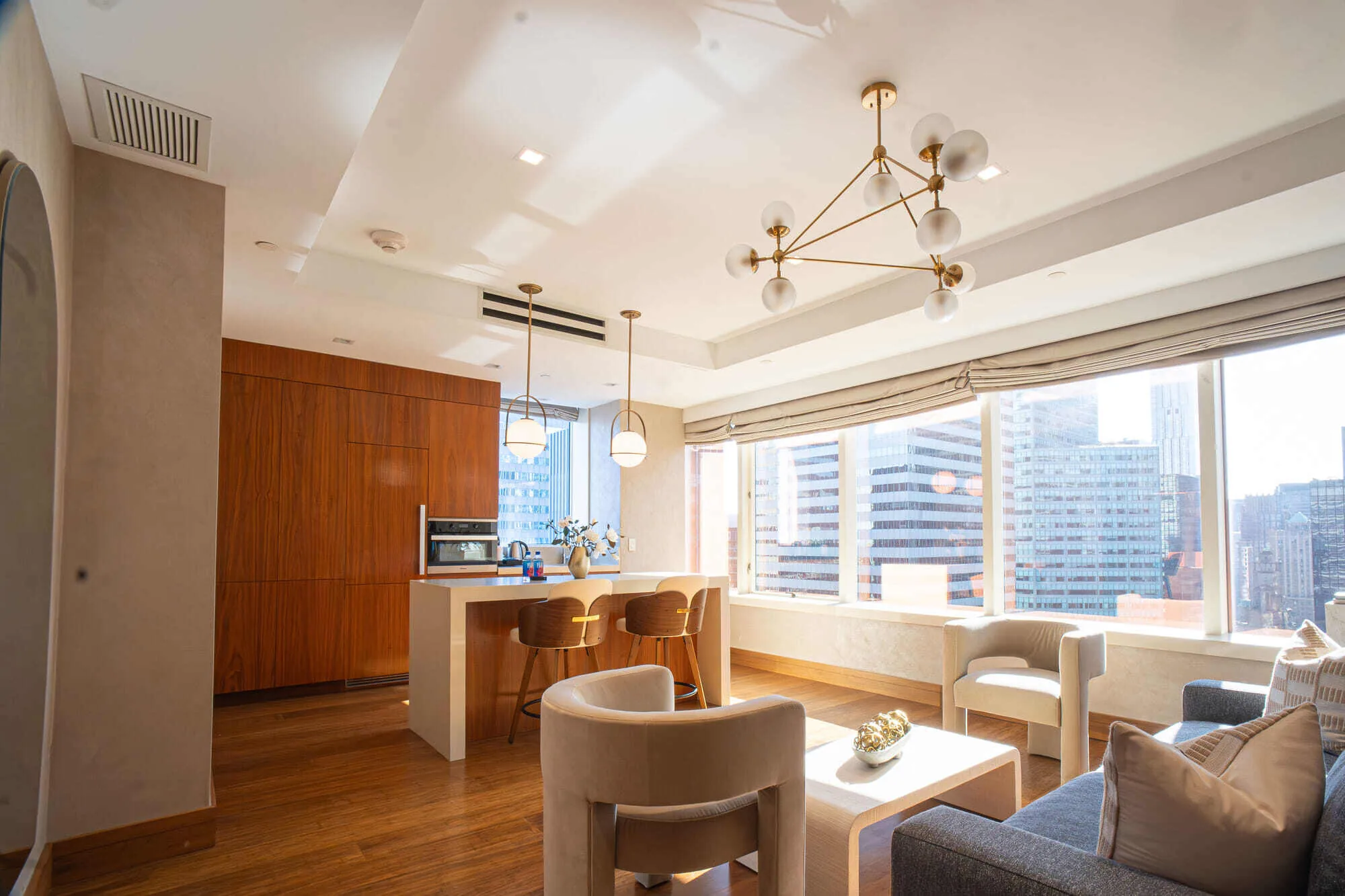 Ambassador suite living and kitchen area with city views at Concorde Hotel New York